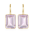 Gold earrings with square purple gemstones on a white background