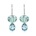 Pair of earrings with blue gemstones on a white background